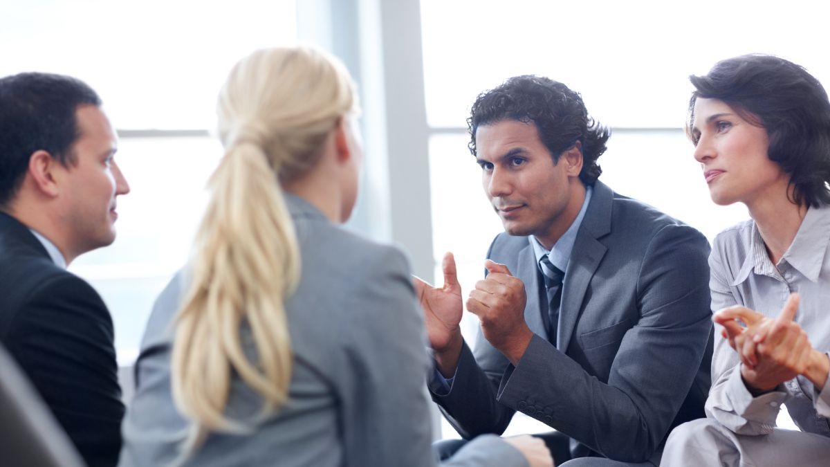 A photo of a team of co-workers having a discussion