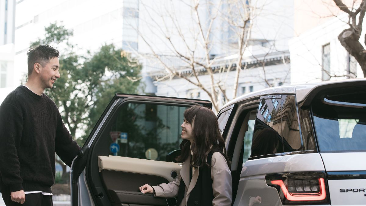 A man opening a car door for a woman